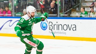 Rögles Mattias Sjögren sträcker ut sina armar och firar ett gjort mål med läktaren i bakgrunden.